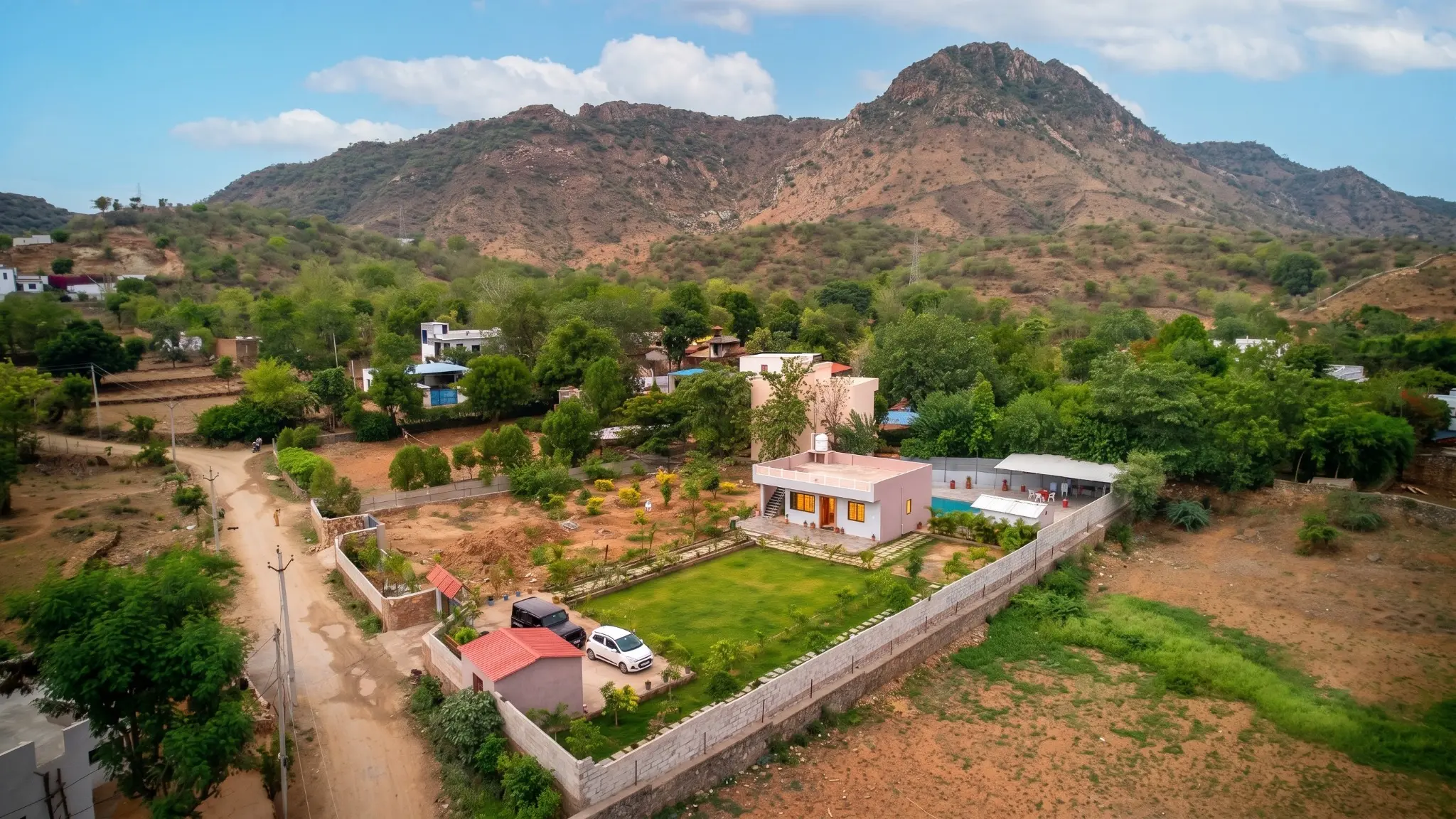 Wide aerial view of Good Vibes Villa near the hills